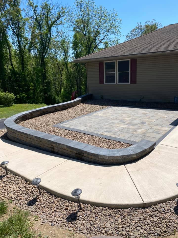Curved patio and retaining edge by JM Outdoor Services