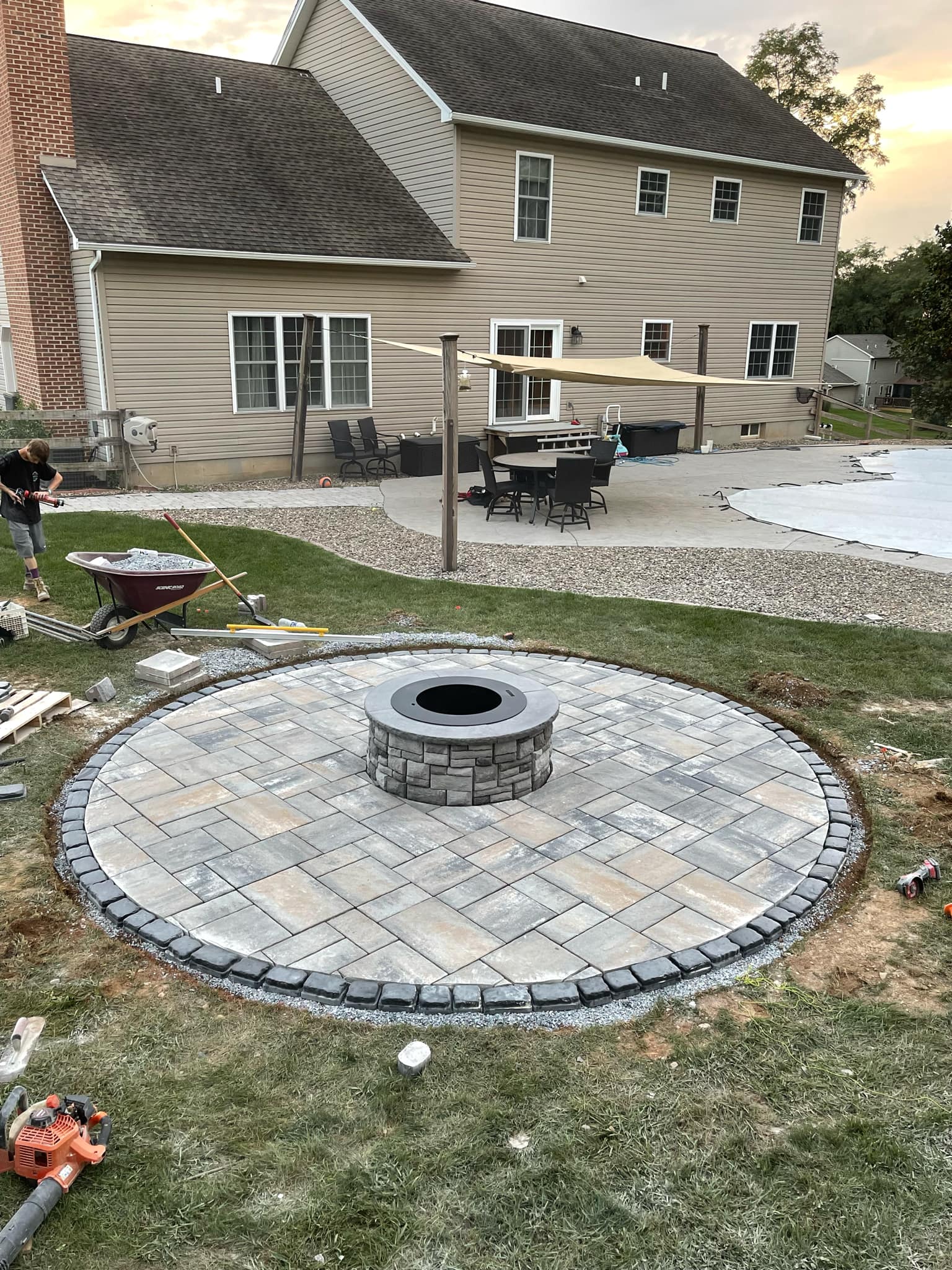 Finished backyard hardscape and outdoor living area by JM Outdoor Services